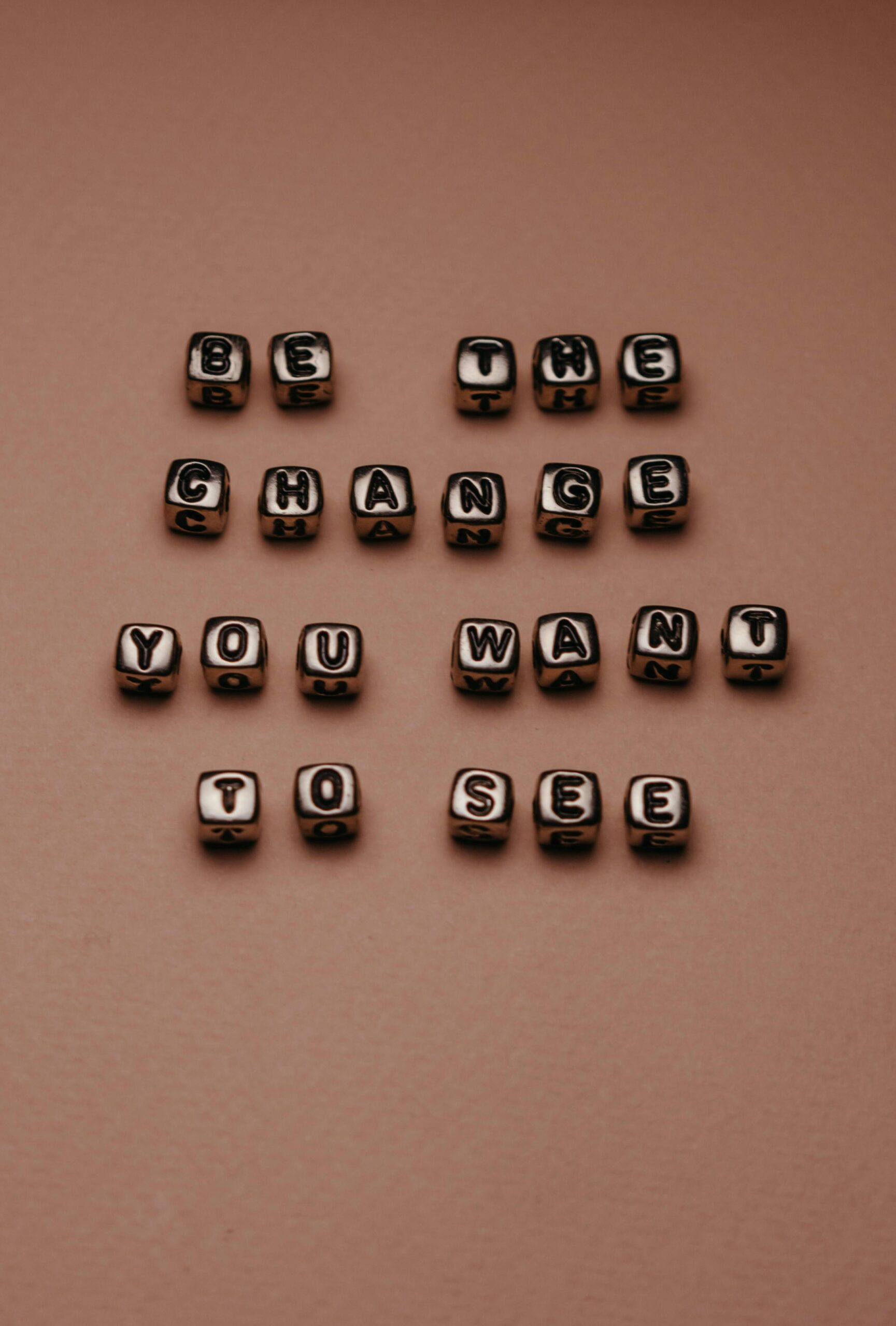 A message created by beads on a brown background.