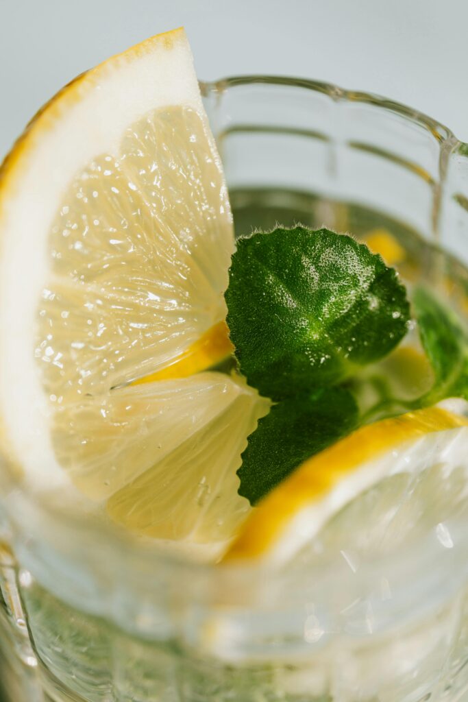 Up close shot of lemonade in a glass with lemon slices.